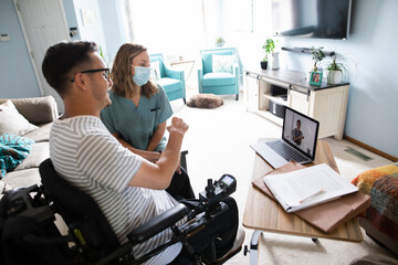Quadriplegic man and healthcare worker on video conference with doctor