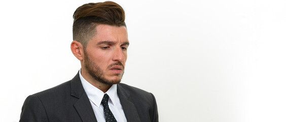 Portrait of handsome bearded Hispanic businessman in suit