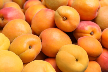 Naklejka na ściany i meble Delicious fresh ripe apricots as background, closeup