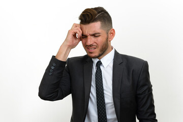 Portrait of handsome bearded Hispanic businessman in suit