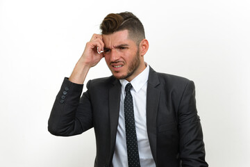 Portrait of handsome bearded Hispanic businessman in suit
