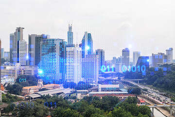 World planet Earth map hologram over panorama city view of Kuala Lumpur, Malaysia, Asia. The concept of international connections and business. Multi Exposure.