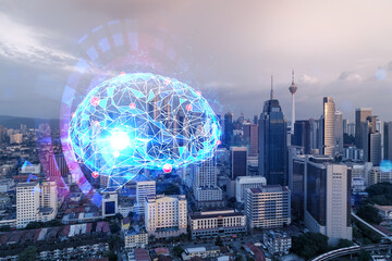 Glowing human brain hologram, aerial panoramic cityscape of Kuala Lumpur at sunset. KL is the center of business education in Malaysia, Asia. Double exposure.