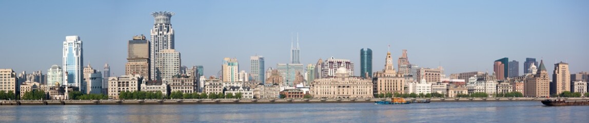 Fototapeta na wymiar Shanghai, China - April 19, 2018: Large panorama of the Bund. One of the landmarks of Shanghai with several historical buidlings and a long waterfront promenade.