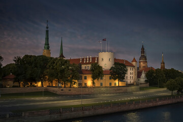 Riga, Latvia. View of the night city across the Daugava River. Riga Castle