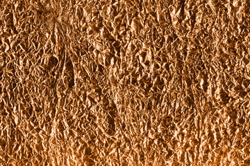 Gold foil texture with folds and cracks. Gradient golden background with high resolution.