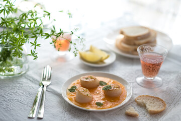Pan Seared Sea Scallops with Orange Tomato Sauce. Glass of Rose Wine