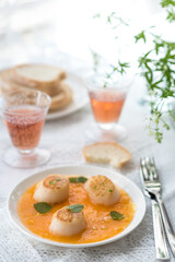 Pan Seared Sea Scallops with Orange Tomato Sauce. Glass of Rose Wine