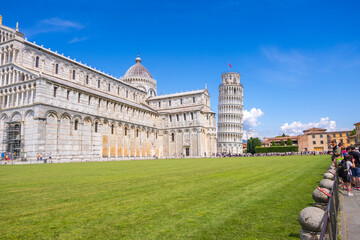 Pisa, Italy - August 14, 2019: View of the Pisa Cathedral with the Leaning Tower of Pisa in Piazza dei Miracoli of Pisa, region of Tuscany, Italy