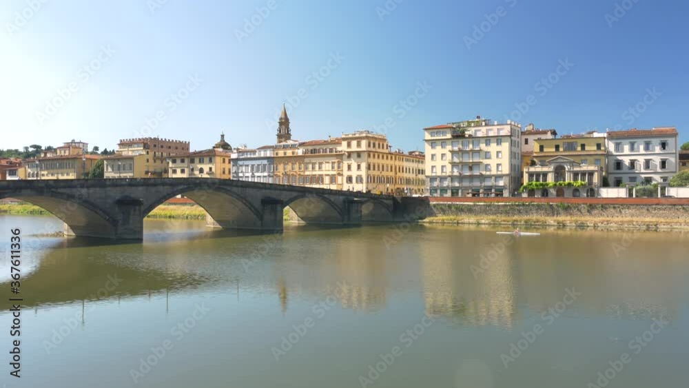 Wall mural a bridge (ponte alla carraia) over the arno river, in a summer morning. a rower in the background.