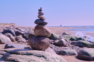 Stone pyramid of rounded stones by the sea