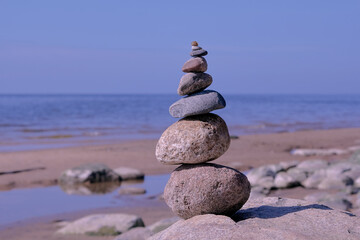 Stone pyramid of rounded stones by the sea