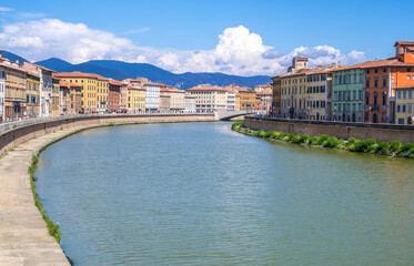 Pisa, Italy - August 14, 2019: Colorful houses at the Arno river waterfront in the historic centre of Pisa city in Tuscany, Italy