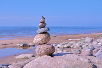 Stone pyramid of rounded stones by the sea