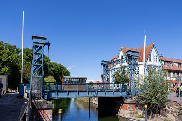 Lift bridge in Plau am See, Germany. It is a steel lift bridge that was built in 1916. With a lifting height of up to 1.86 m, it is the highest lifting bridge in Mecklenburg. - obrazy, fototapety, plakaty
