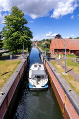 Naklejka na ściany i meble motorboat in the river Elde lock in Plau am See, Germany
