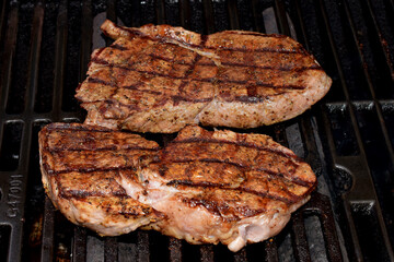 Sirloin steaks cooking on the grill