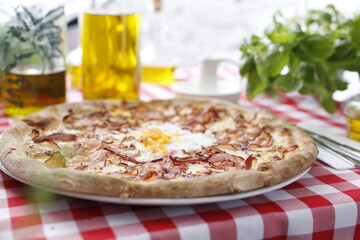 Pizza with bacon, onion, and egg. Italian cuisine.
Traditional Italian pizza. Suggestion to serve a dish. Food background.