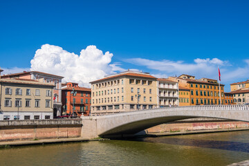 Pisa, Italy - August 14, 2019: The Ponte di mezzo or Middle bridge and Piazza Garibaldi with statue of Giuseppe Garibaldi in Pisa, region of Tuscany