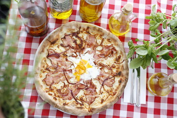 Pizza with bacon, onion, and egg. Italian cuisine.
Traditional Italian pizza. Suggestion to serve a dish. Food background.