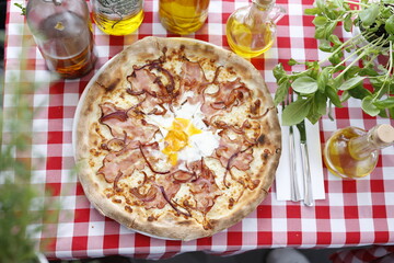 Pizza with bacon, onion, and egg. Italian cuisine.
Traditional Italian pizza. Suggestion to serve a dish. Food background.