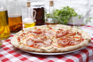 Pizza with ham and zucchini and mozzarella cheese. Italian cuisine.
Traditional Italian pizza. Suggestion to serve a dish. Food background.