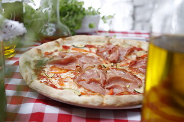 Pizza with ham and zucchini and mozzarella cheese. Italian cuisine.
Traditional Italian pizza. Suggestion to serve a dish. Food background.