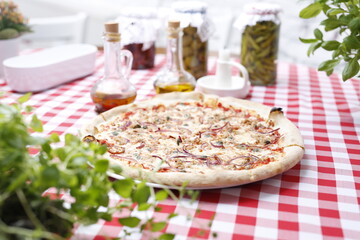 Pizza with tuna, onion, capers, and mozzarella cheese. Italian cuisine.
Traditional Italian pizza. Suggestion to serve a dish. Food background.