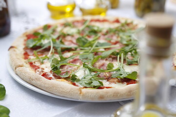 Pizza with ripening ham and arugula.
Traditional Italian pizza. Suggestion to serve a dish. Food background.