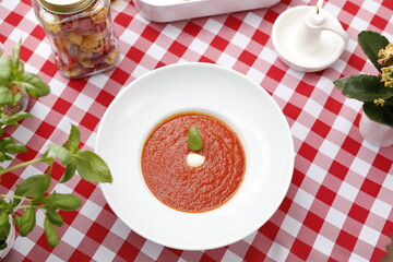 Cream of ripe tomatoes with herbs.
Suggestion to serve a dish. Food background.