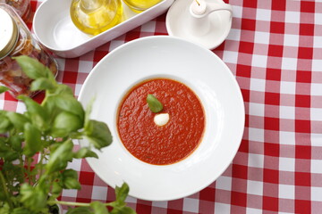 
Tomato soup with basil and cream.
Suggestion to serve a dish. Food background.