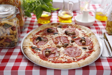 Pizza with salami and mushrooms. Italian cuisine.
Traditional Italian pizza. Suggestion to serve a dish. Food background.