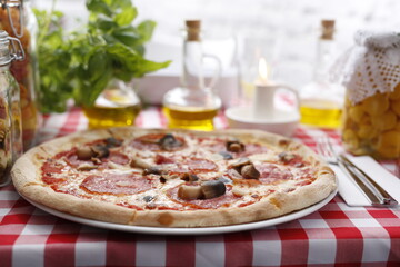 pizza with salami and tomatoes