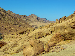 A view from the base of Mount Sinai towards a distant bedouin camp in Egypt in summer