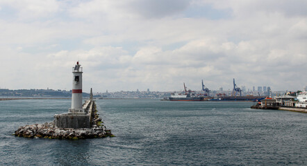 Lighthouse in the Bosphorus. Breakwater in the Bosphorus. Mossy cliffs