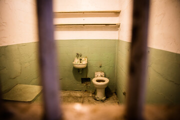 old prison cell behind bars