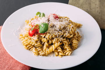 Photo of beautiful and tasty pasta made with love on black table.