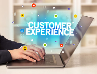 Freelance woman using laptop with CUSTOMER EXPERIENCE inscription, Social media concept