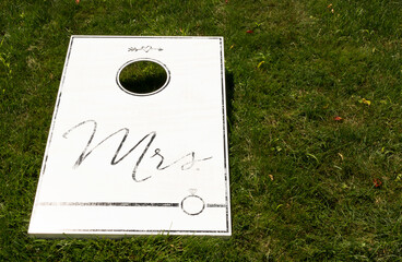 White wooden cornhole with Mrs written in black