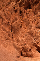 Geology. Natural texture. Closeup of the red and orange rock formation in the desert mountain. 