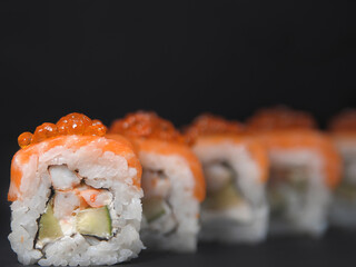 Japanese rolls food on dark background.