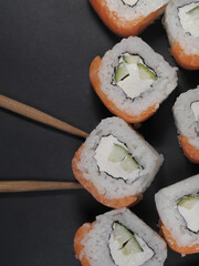 Japanese rolls food on dark background.