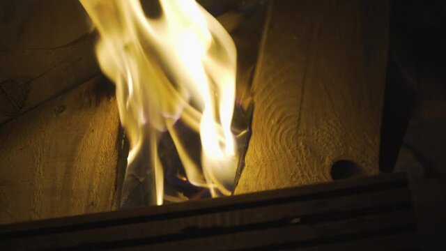 Flames starting to burn fresh wood in bonfire, 4k