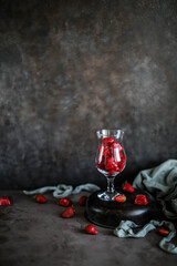 Strawberry ice in a beautiful glass against a dark background. Berry cold dessert.