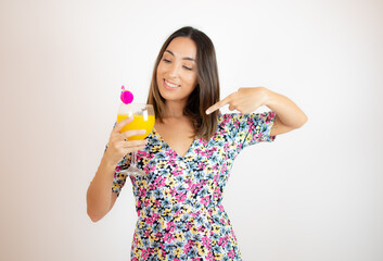 Pretty woman in colorful dress with a cocktail