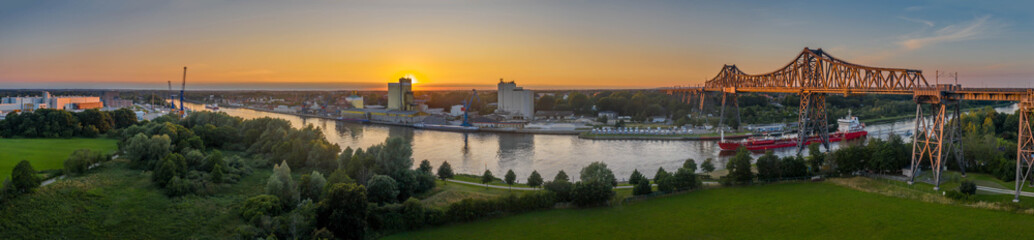 Panoramic aerial view of famous railway Rendsburg High Bridge with cargo ship and the camping...