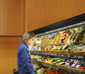 Supermarket shopping, man buying vegetables at the market