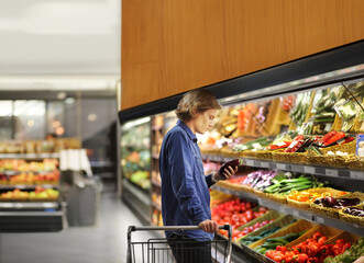 Supermarket shopping, man buying vegetables at the market