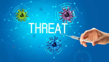 Syringe, medical injection in hand with THREAT inscription, coronavirus vaccine concept