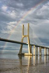 Obraz premium Rainbow on the Vasco de Gama Bridge, Lisbon, Portugal